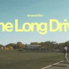 7877 the long drive hd title slide Community gathering at a golf range, focusing on fellowship and teamwork, with vibrant autumn trees in the background.
