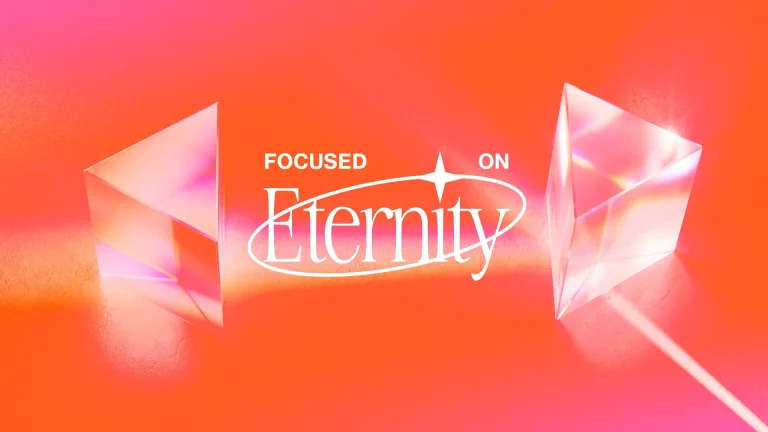 Bright orange background with geometric prisms and the text "Focused on Eternity," symbolizing faith and spiritual reflection.