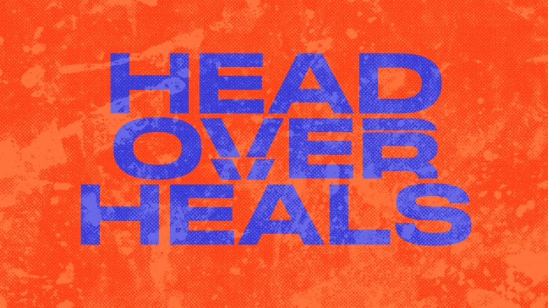 Bold text reads "HEAD OVER HEALS" on a vibrant orange background, symbolizing love and devotion in faith.