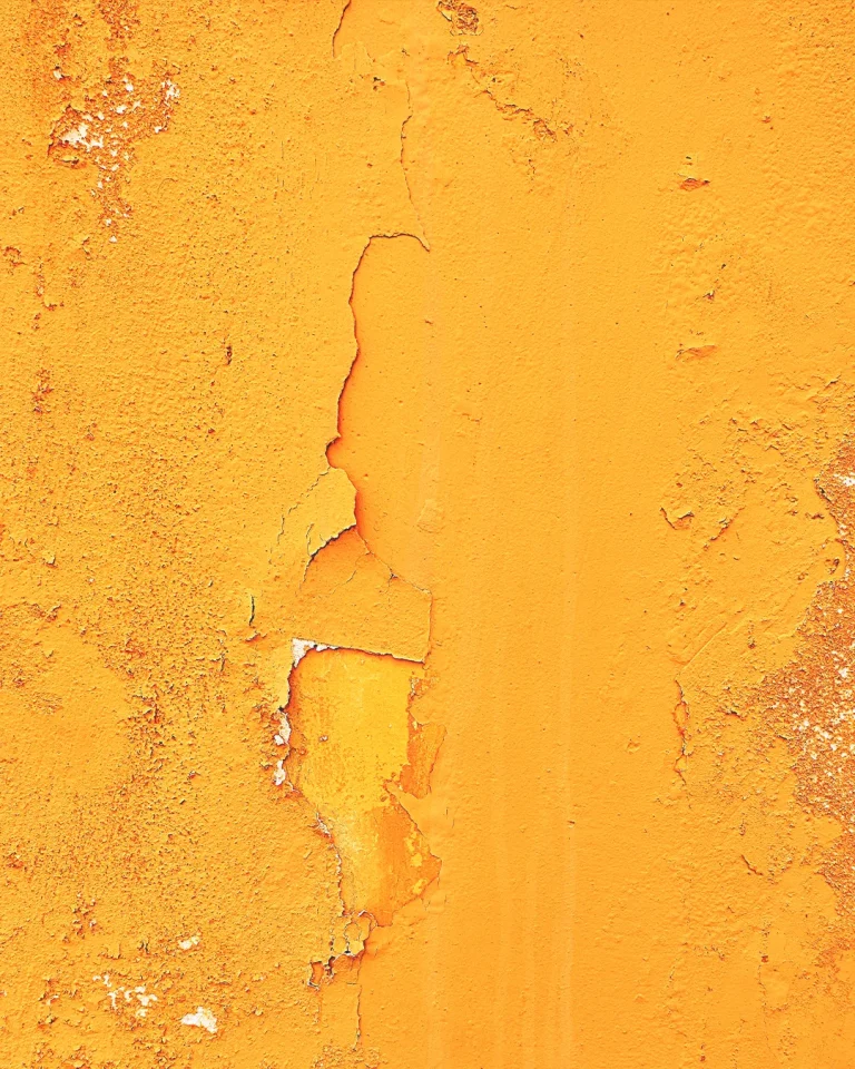 Peeling orange wall symbolizing renewal and transformation, reflecting spiritual growth and church restoration.