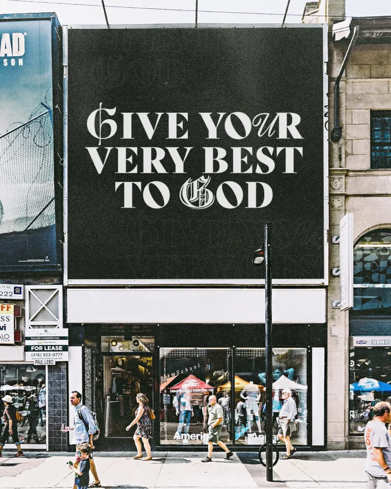 "Give your very best to God" billboard above busy urban street, promoting worship and faith in everyday life.