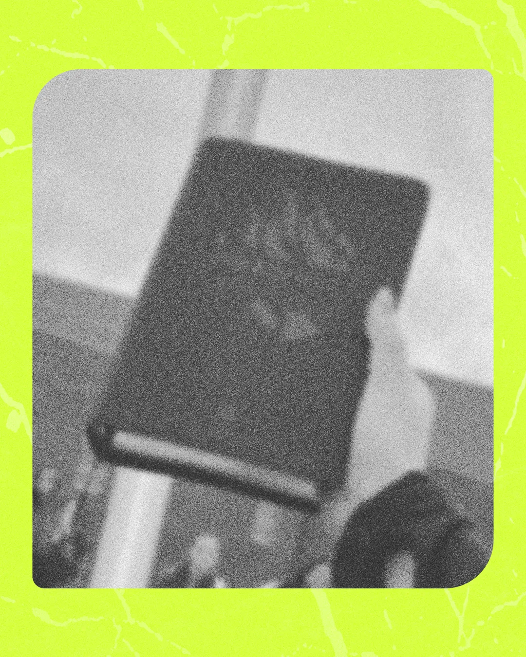 A hand holds a Bible high, symbolizing worship and faith amid a blurred congregation.