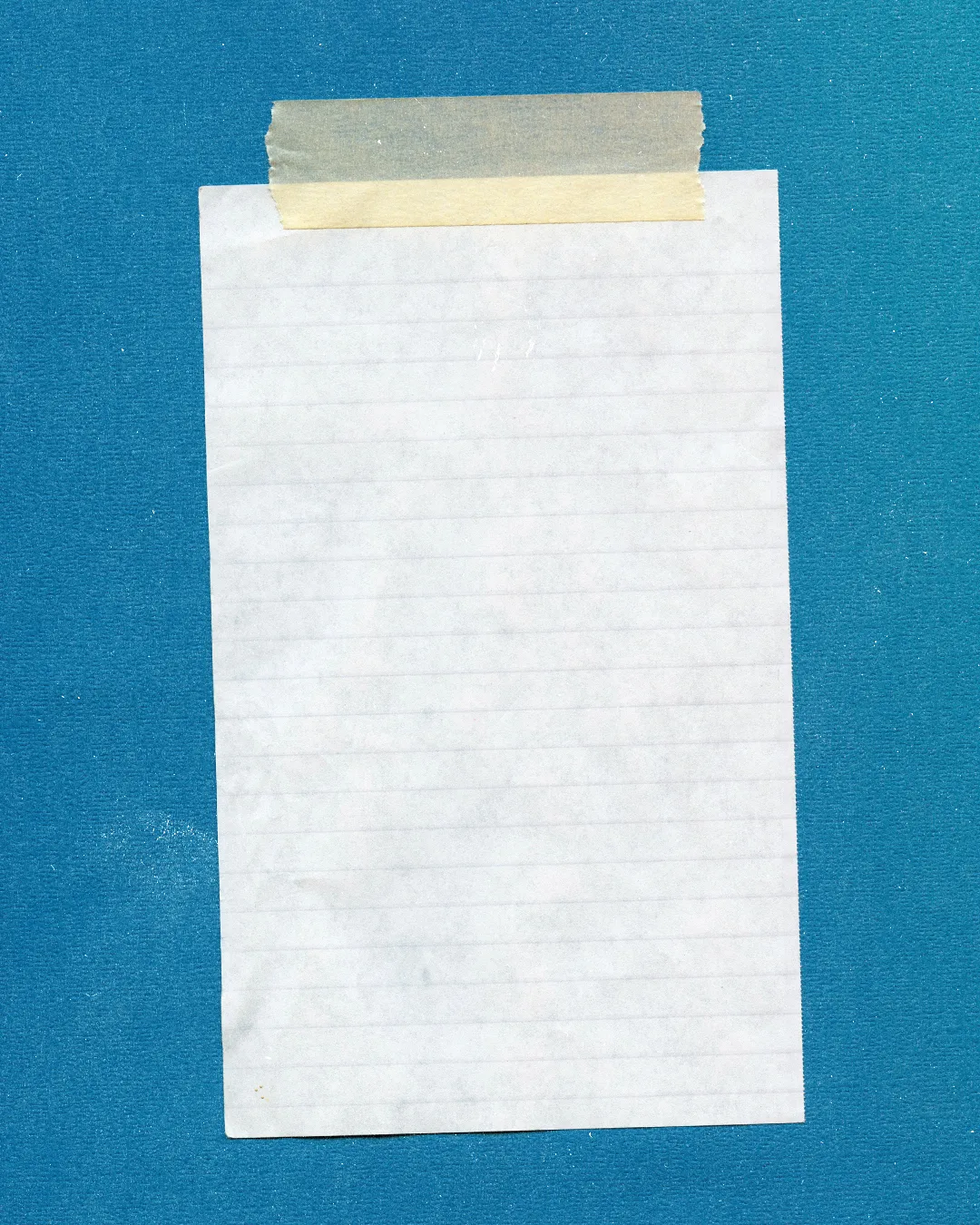 Blank notepad with a tape strip, symbolizing prayer requests, notes for sermons, or community reflections in faith.