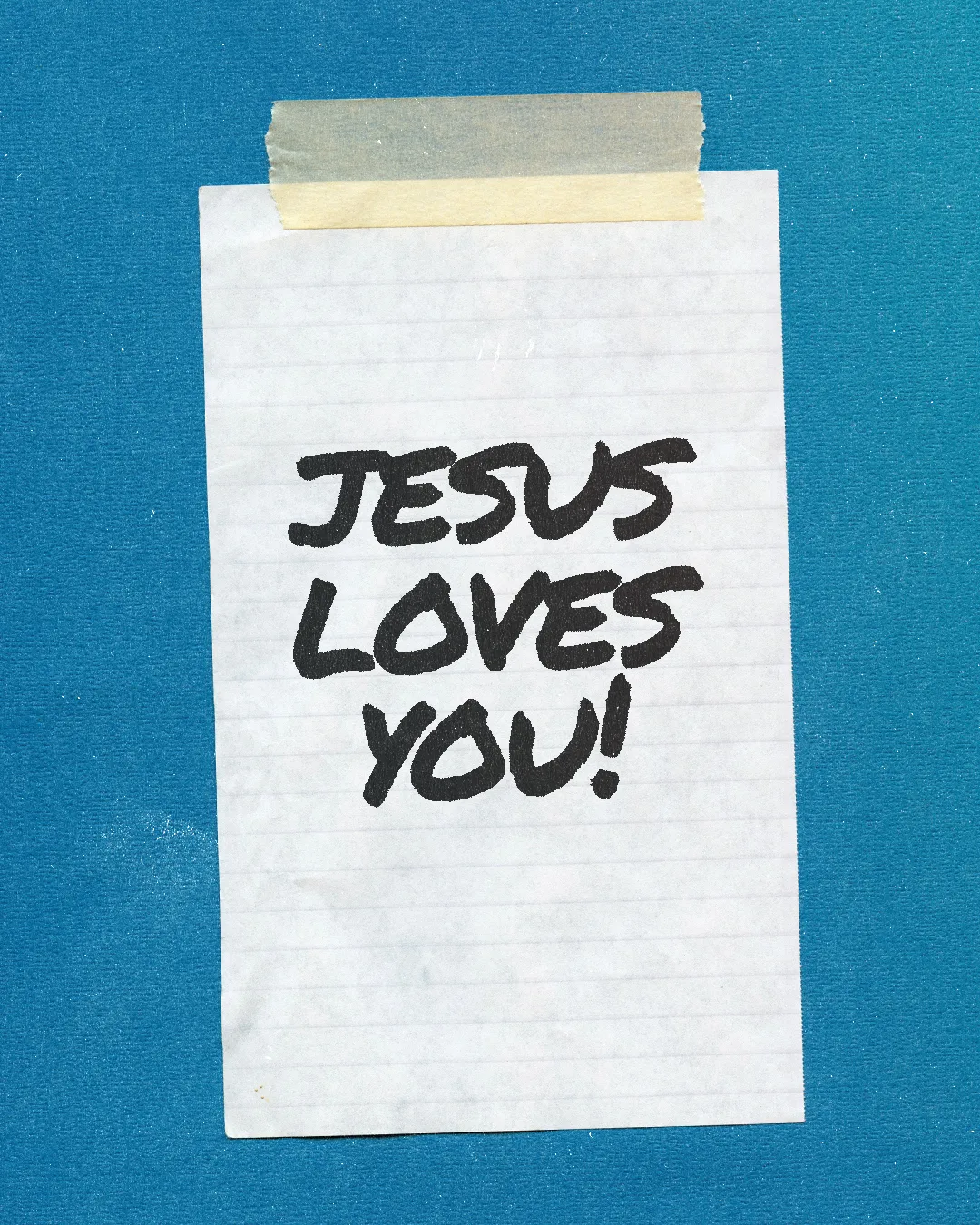 "Handwritten note on blue background: 'Jesus loves you!' emphasizing faith and community encouragement."