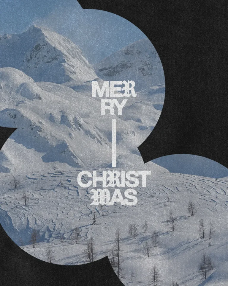 Snowy mountains with "Merry Christmas" text, evoking themes of peace, joy, and the spirit of the holiday season.