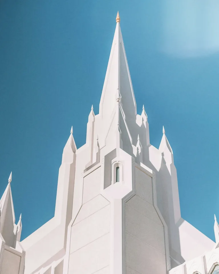 Majestic church spire reaching towards the sky, symbolizing faith and community under a bright blue backdrop.