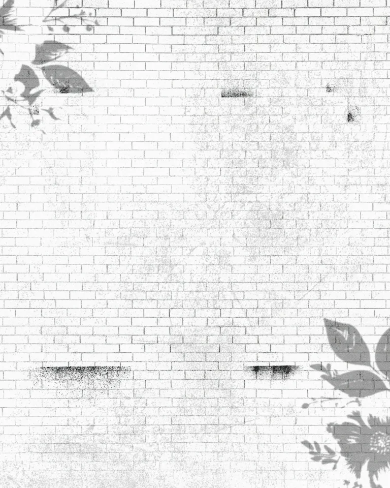 Textured white brick wall adorned with subtle floral patterns, symbolizing growth and community in faith.