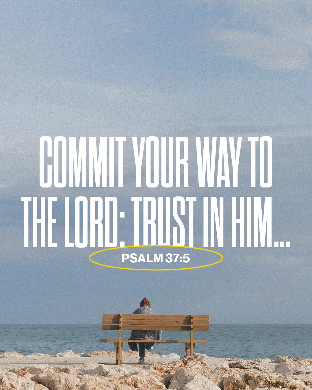 Person seated on a bench by the sea, reflecting on Psalm 37:5, emphasizing trust and faith in the Lord.
