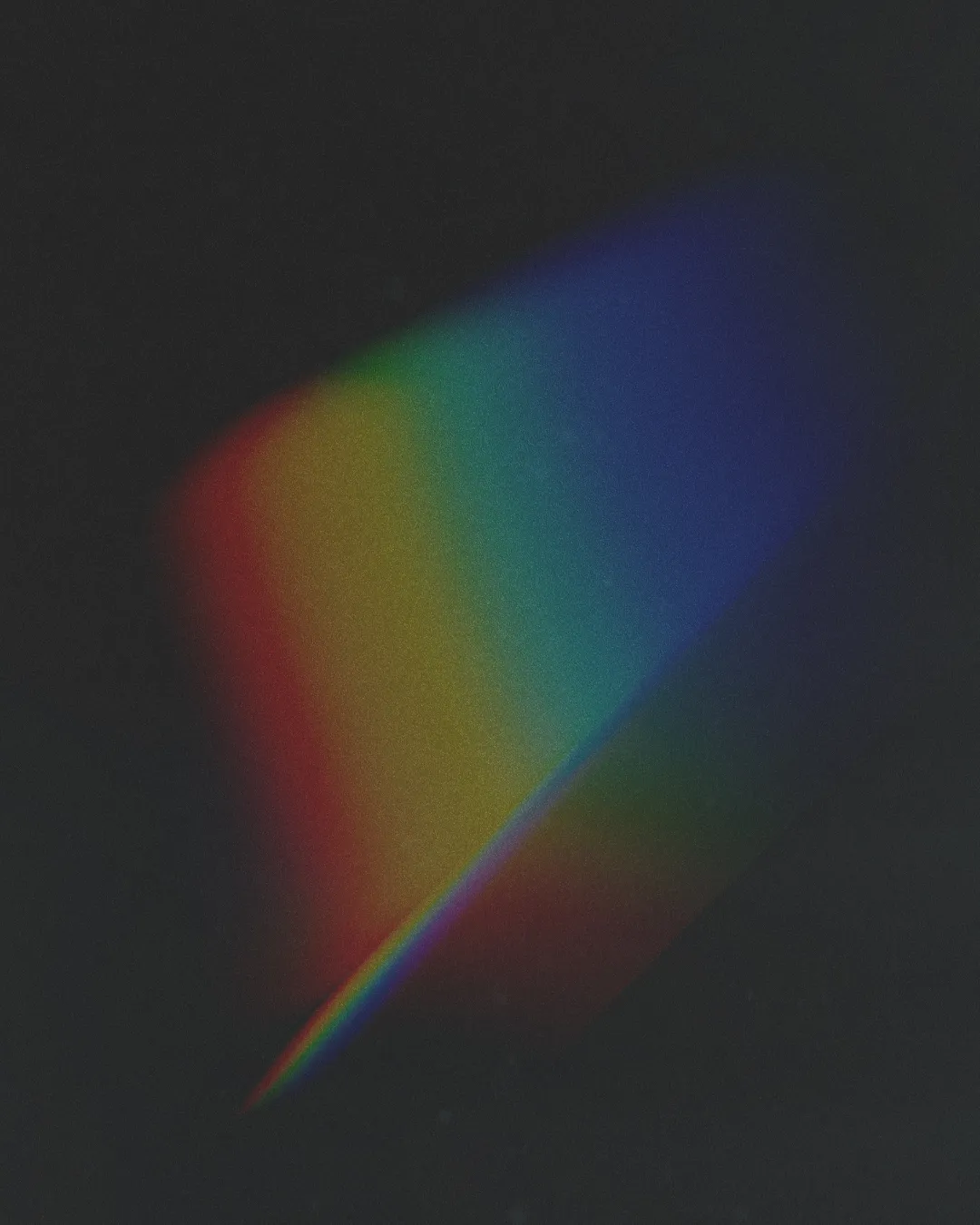 Vibrant rainbow spectrum on a dark background, symbolizing hope, diversity, and the light of faith.