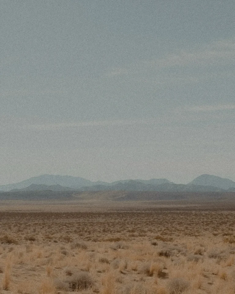 Vast desert landscape under a serene sky, symbolizing spiritual journeys and God's creation.