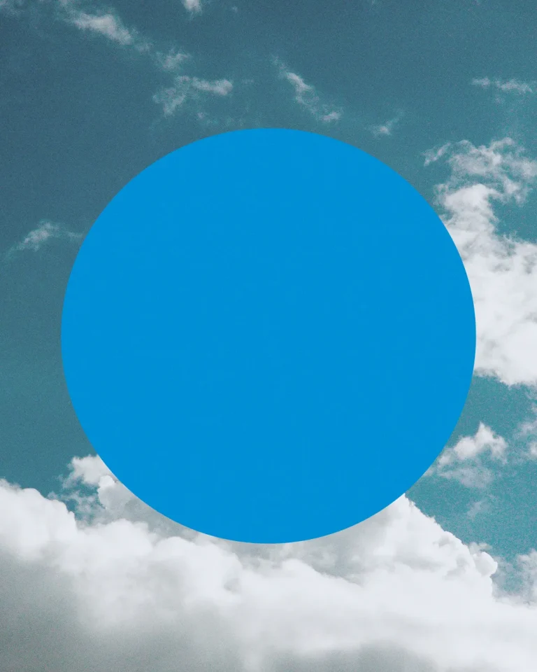 Bright blue circle against a backdrop of clouds, symbolizing hope and divine connection in worship and community.