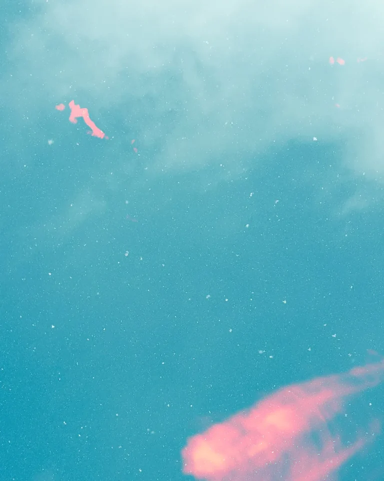 Soft clouds reflect warm hues on tranquil water, symbolizing peace, hope, and divine presence in worship.