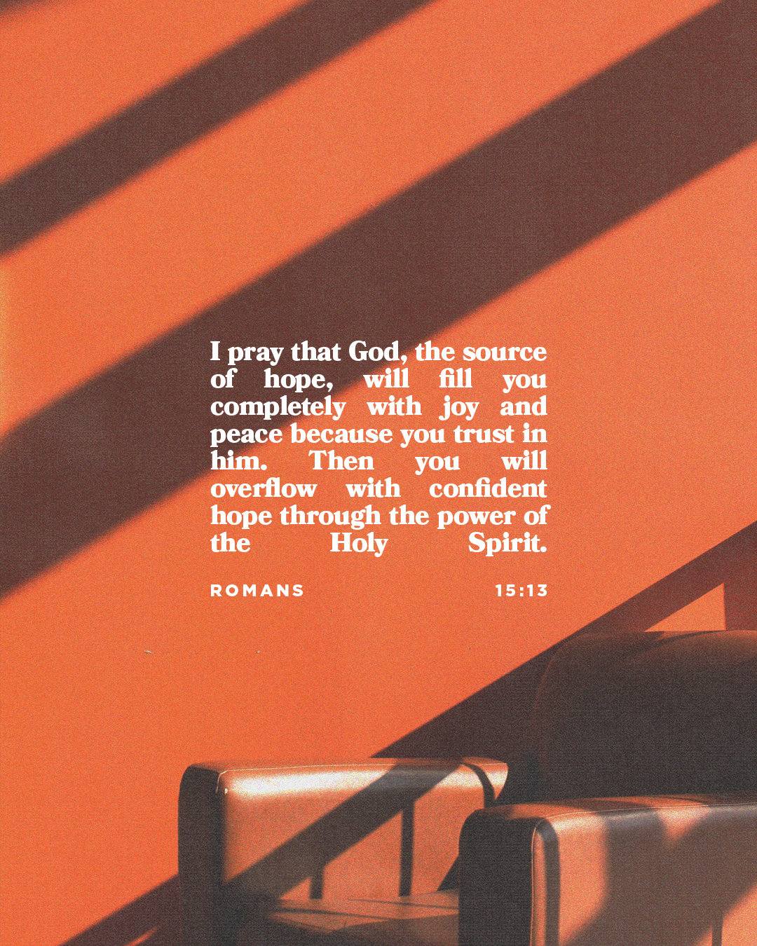 Warm orange background with a scripture from Romans 15:13 about hope, joy, and the Holy Spirit, alongside a simple chair.