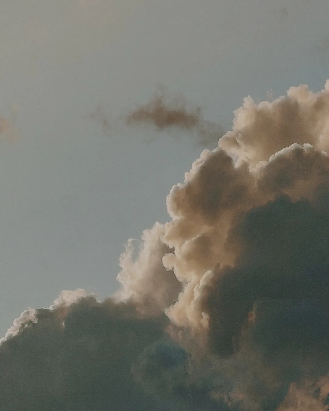 Majestic clouds illuminated by sunlight, symbolizing divine presence and hope in faith and community.